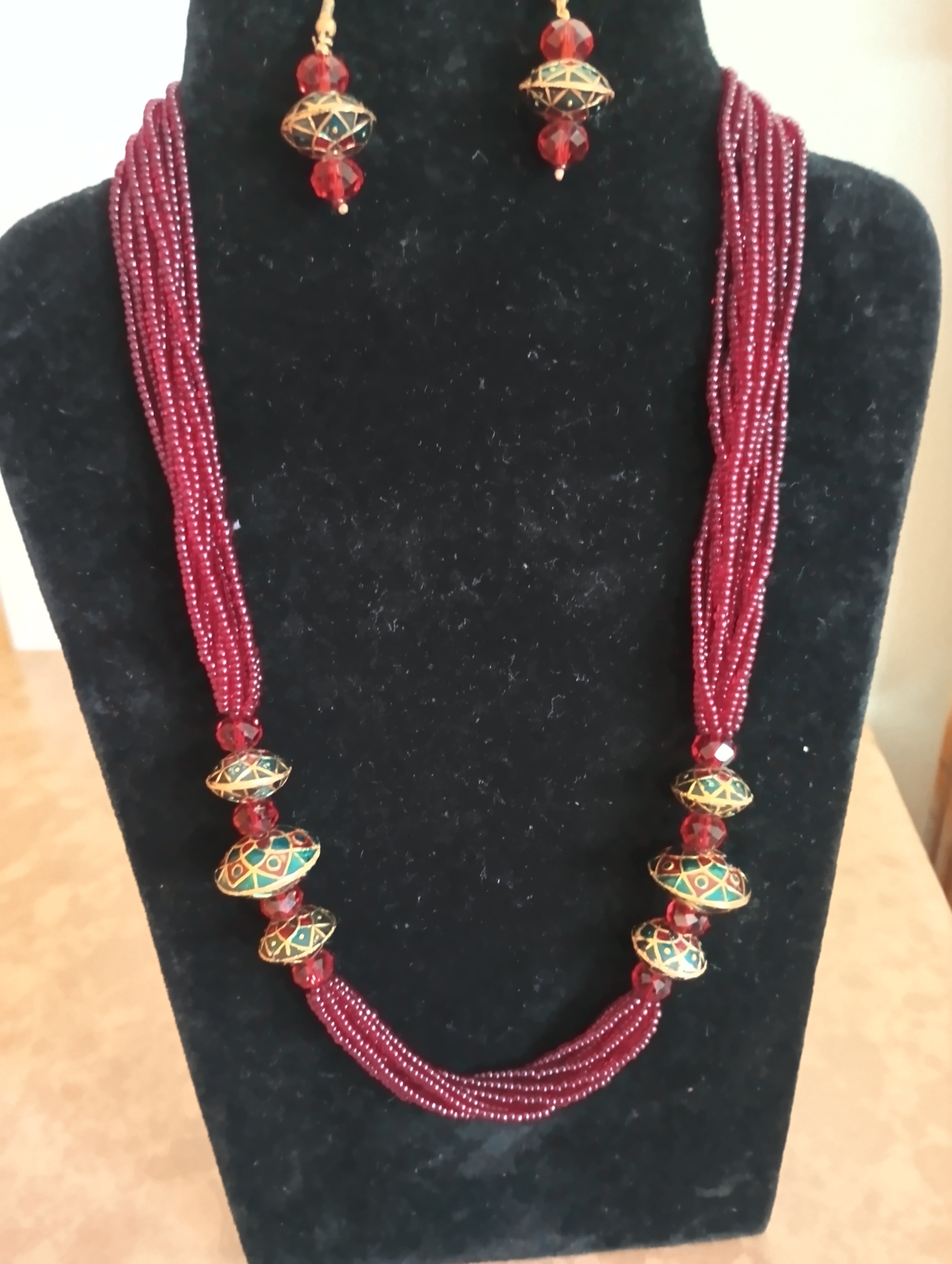 Multi-strand maroon beaded necklace set with meenakari beads