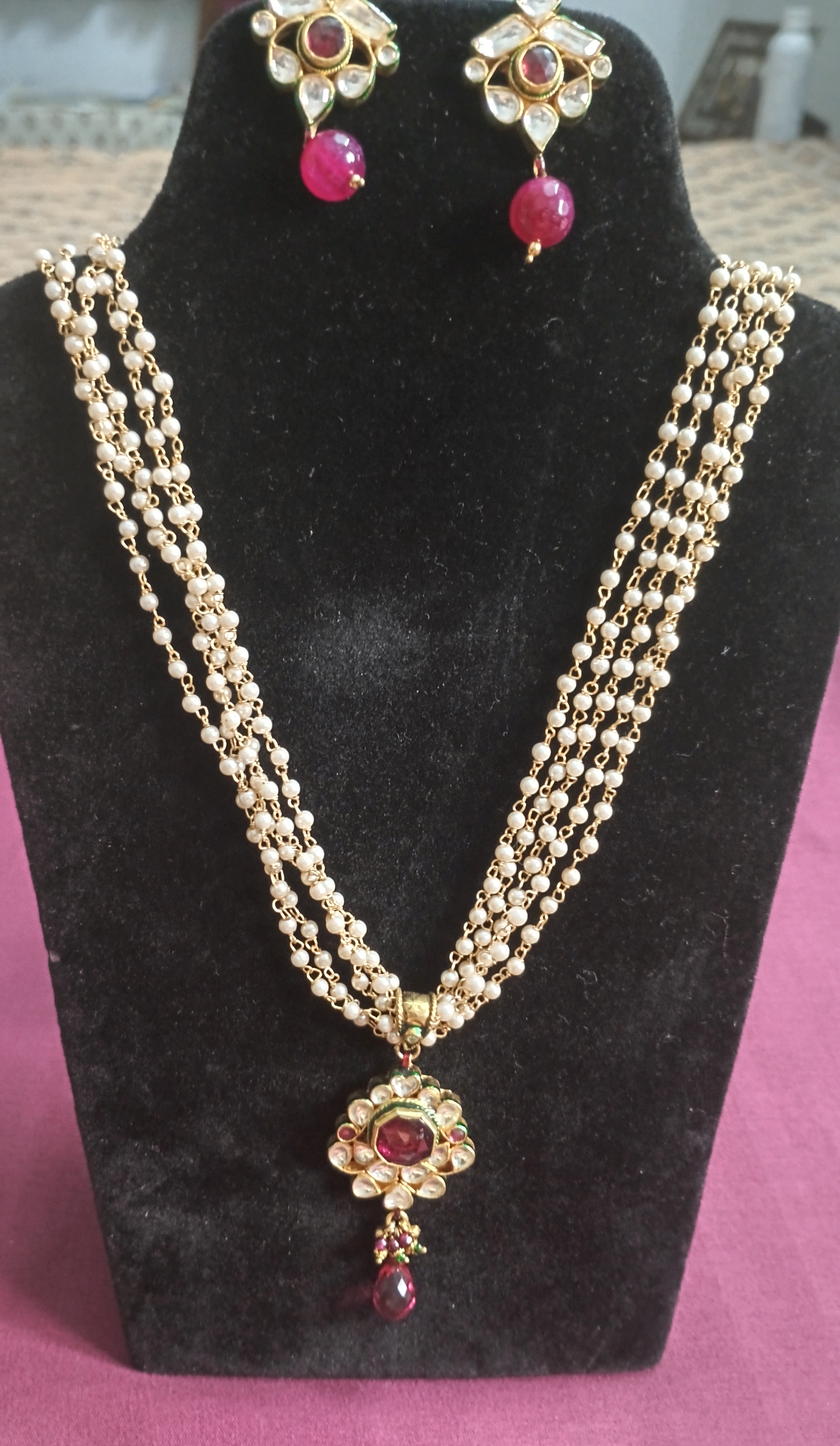 Pearl and gold multi-strand necklace with kundan pendant and earrings