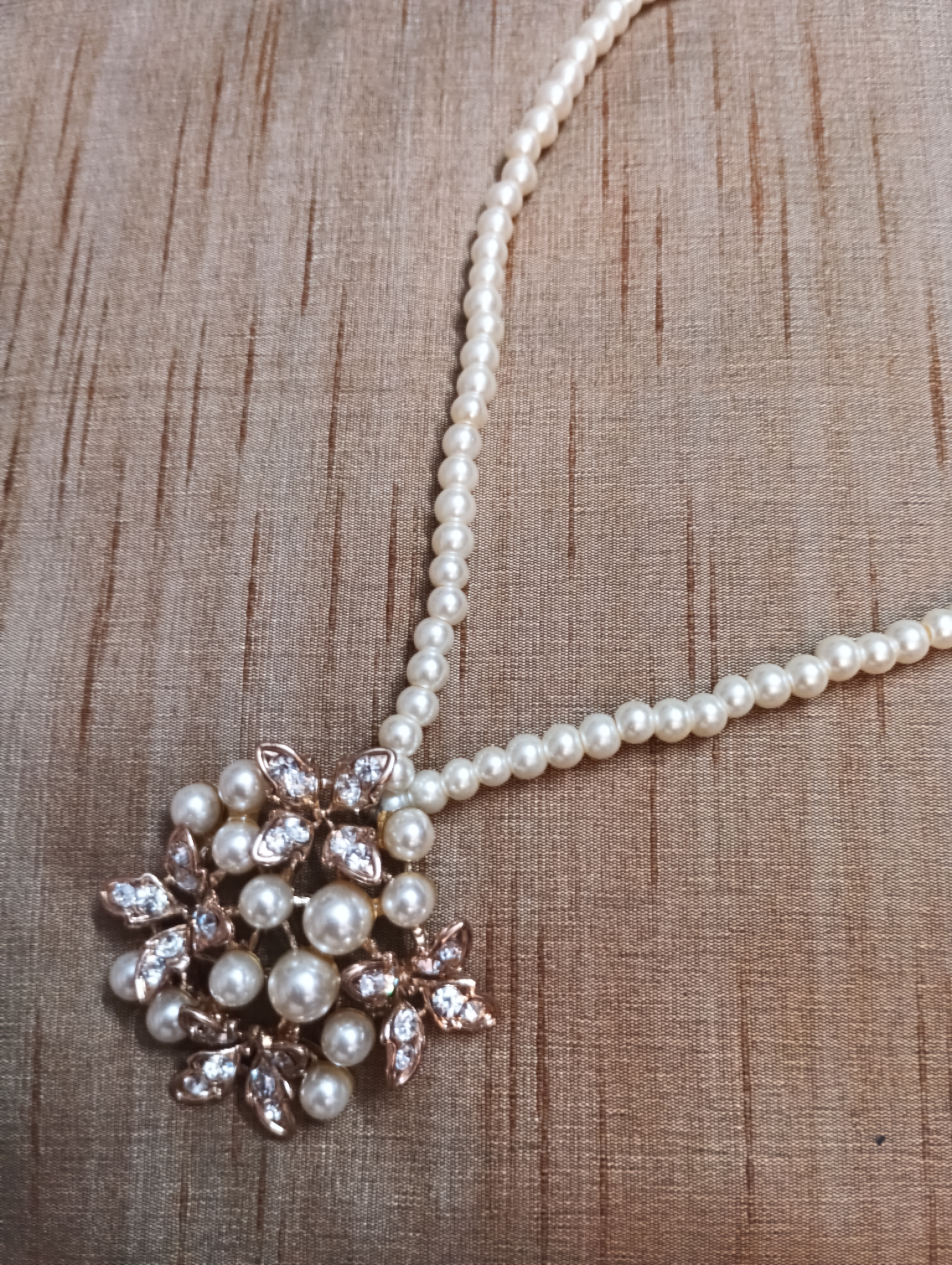 Pearl necklace with gold and pearl pendant